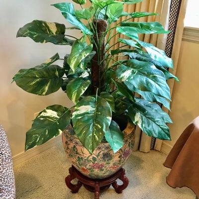 Large Chiness porcelain planter with foliate motif on a carved wood stand.  $250