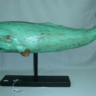 Carved wooden whale on metal stand
