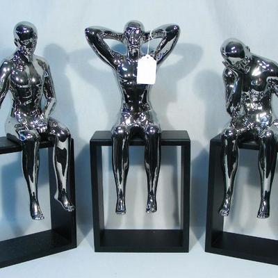 Group of three chromed seated men