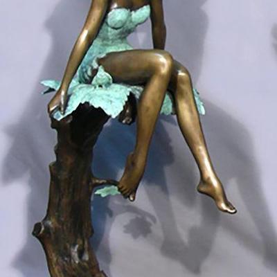 Bronze sculpture of girl seated on maple leaf