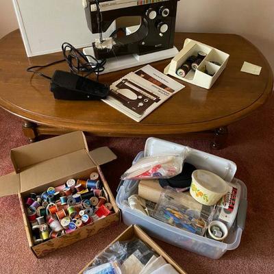 Husqvarna sewing machine with tons of thread, needles and sewing items.  Sewing machine works fine.