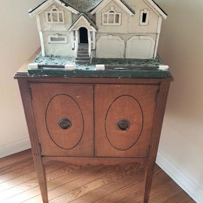 Cabinet is for sale but the home model on top is not for sale.  Thanks