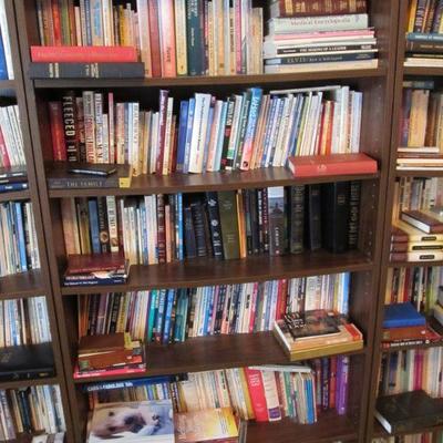 A large collection of religious, rare, spiritual books, & Bibles.  Plus several nice wood shelves for storage.
