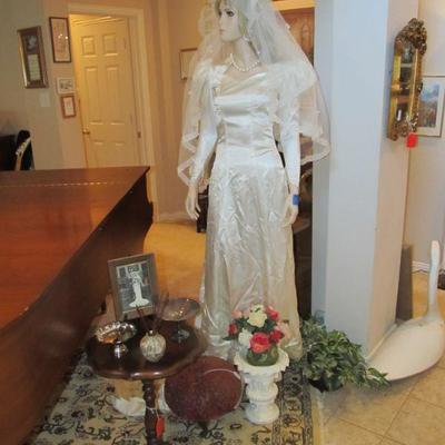 A stunning 1940s handmade wedding gown w/ button going down the back & a long trail. 