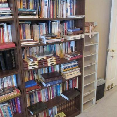 A large collection of religious, rare, spiritual books, & Bibles.  Plus several nice wood shelves for storage.