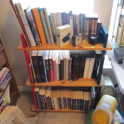 A large collection of religious, rare, spiritual books, & Bibles.  Plus several nice wood shelves for storage.