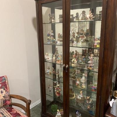 Collectible figurines and lighted display cabinet