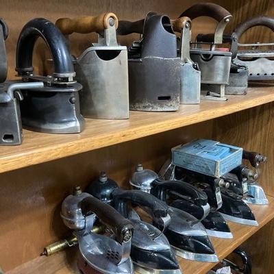 Over 700 sad irons, charcoal irons, slug irons, miniature irons, streamline Art Deco electric irons, kerosene irons, natural gas irons,...