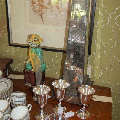 Silver goblets and foo dogs