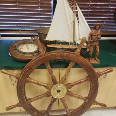 566	
Model Ship, Wood Statue, Port Hole Clock, Book Ends, Metal Bucket And More
Helm Measures Approx 39