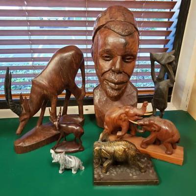 572	
5 Wooden Statues, Metal Statue, And Stone Statue
Measurements Range 4.5