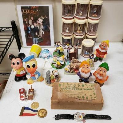 84	
Disneyana
Includes Snow White Figurines, Goofy Ceramic Mold, Rattles, And More