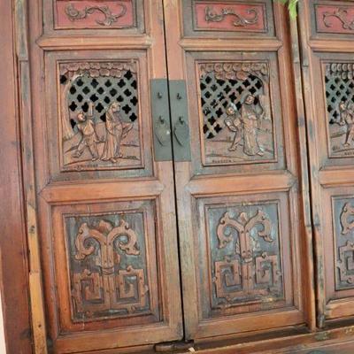 Showing carved doors of Asian wedding cabinet