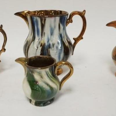 1189	GROUP OF 4 DECORATED COPPER LUSTER CREAMERS, TALLEST IS 6 IN
