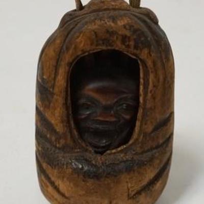 1084	ASIAN CARVED FACE IN A CARVED OUTER CASING, 4 1/2 IN HIGH
