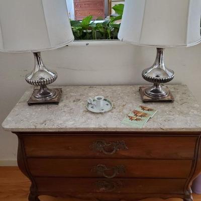 Silver overlay lamps with bow front marble top chest