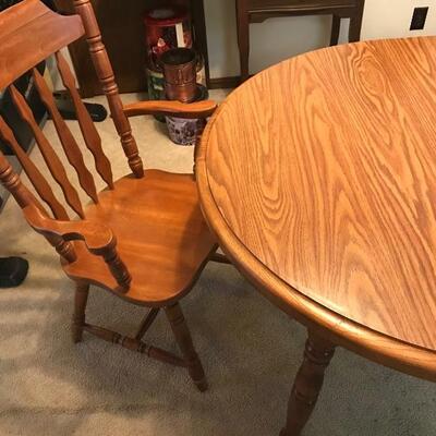 Oak table with 2 leafs, 7 regular chairs plus one captains chair.