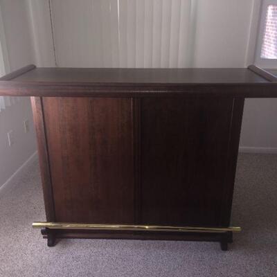 Beautiful Wood Bar with Brass Rail (front).  Top 60x24 and 41 tall. Base is 46x17