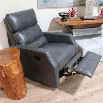 MANUAL LEATHER RECLINERS THERE IS A SET OF 2 IN GREY. 
Wood stump not for sale 