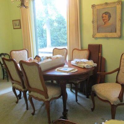 Dining room table & chairs, antique dolls, linens & portrait - she's got 'Betty
Davis eyes'.