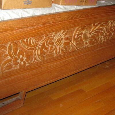 Beautifully carved foot board on this bed