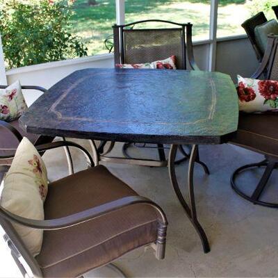 Fabulous five piece outdoor dining set is in like new condition.  All four chairs swivel and rock.  Cushions included.
