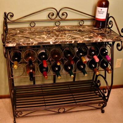 Decorative iron wine rack features a gorgeous marble top.