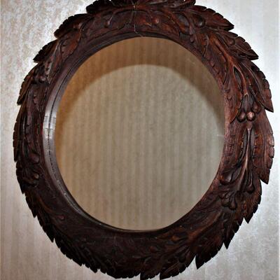 Ornate carved wooden framed mirror.