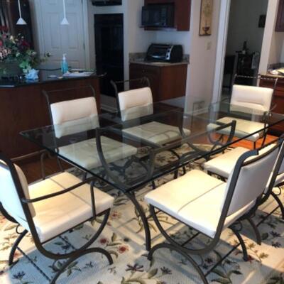 Wrought iron glass top table with 6 leather chairs
295.00