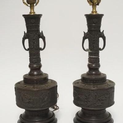 1070	5031	PAIR OF ASIAN BRASS LAMPS	PAIR OF ASIAN BRASS LAMPS HAVE FIGURAL HANDLE & RELIEF DECOARATION PART OF ONE WOODEN BASE IS DAMAGED...