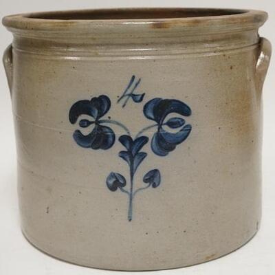 1003	FOUR GALLON BLUE DECORATED STONEWARE CROCK HAS A SMALL CHIP ON THE INNER TOP RIM. 10 1/4 IN H 12 T DIAMETER 
