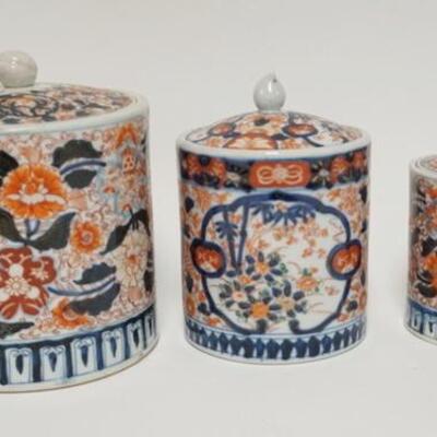 1048	5031	3 IMARI TYPE ASAIN CANISTERS	THREE IMARI TYPE ASIAN CANSITERS THEY HAVE FRUIT FINIALS LARGEST IS 8 1/4 IN H 6 5/8 IN DIAMETER...