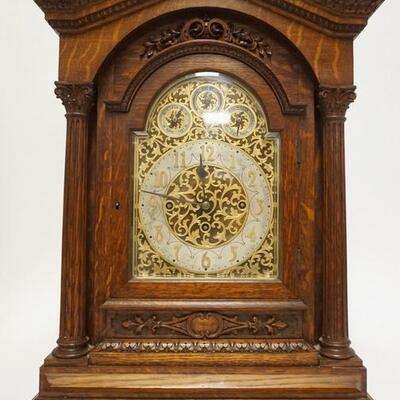 1002	ORNATE VICTORIAN CARVED OAK CLOCK; QUARTER SAWN OAK W/ FINE CARVINGS HAS FULL FLUTED COLUNMS & FRETWORK SIDE DOORS CLOCK HAS TWO...