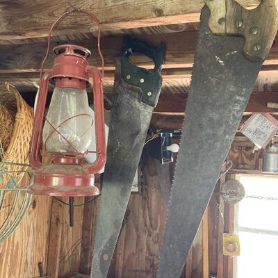 Vintage hand saws and lantern