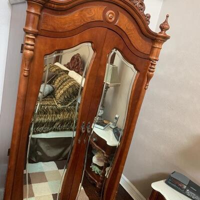 Mirrored, arched cornice armoire