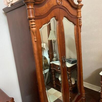 Mirrored, arched cornice armoire
