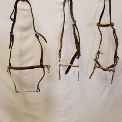 64	

Three Assorted Cowboy Bridles and Parts.
Three Assorted Cowboy Bridles and Parts.