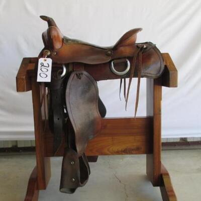 200	

Cowboy Ranch Saddle
Western Ranch Saddle.  15 1/2 inch seat.  Kids size safety tapadero stirrups.  Saddle complete with latigo,...