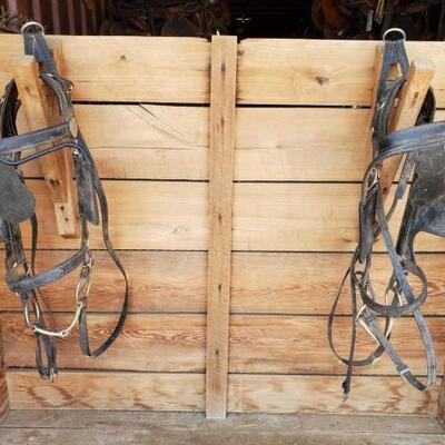 307	

Two Draft Horse Bridles and Reins for a Team
Two Draft Horse Bridles for a Team
Made of black patent leather 
Leather is dusty in...