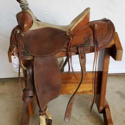 237	

KM Saddlery Rope Saddle
16" KM Saddlery Rope Saddle of Chowchilla.Ca. Serial # 143. Sterling silver conchos. Has 4"...