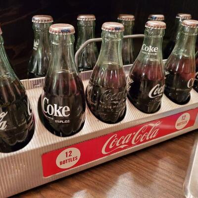 Coca cola bottles and carrier