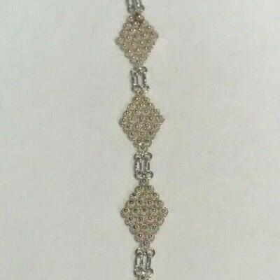 https://www.ebay.com/itm/124408415358	WL168 STERLING SILVER DIAMOND PATTERN BRACELET WITH LOBSTER CLASP 		 Auction 
