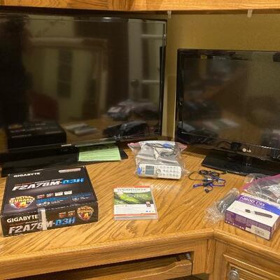 Two flat screen televisions and computer accessories