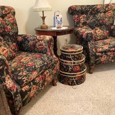 Floral chairs with matching hat box accents.
