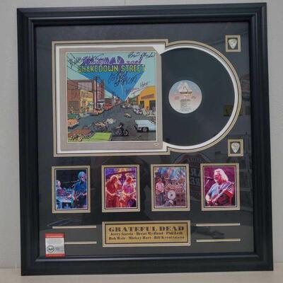 1002	

Framed Grateful Dead Signed Vinyl Record Album with COA
Includes COA by Pinpoint Signature Authentication Services. Cert No:...
