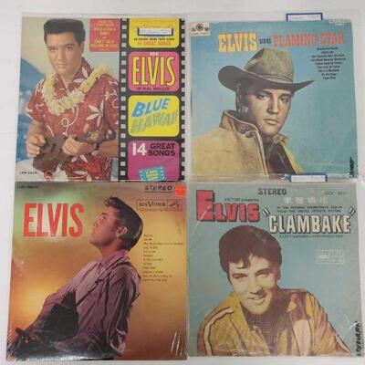 1018	

4 Elvis Presley Record Albums
Includes Blue Hawaii, Clambake, Flaming Star and Elvis Presley