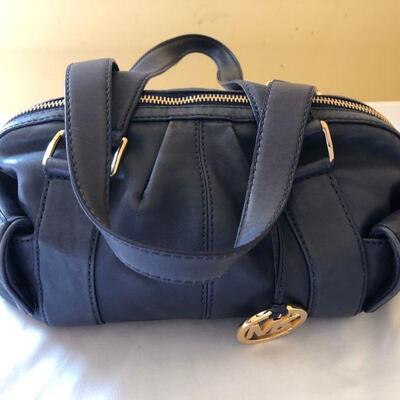 Michael Kors medium size handbag with gold accents and side pockets.  In good shape. 
