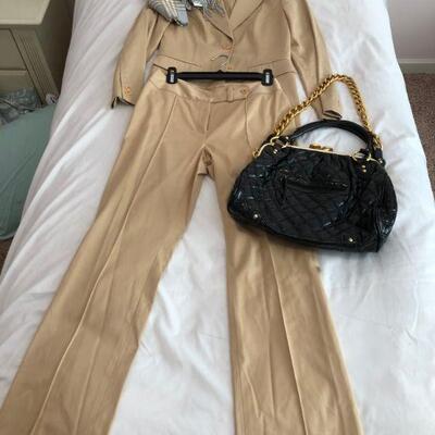 Women's Khaki suit with black patent purse and scarves. 