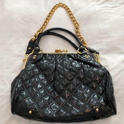 Black patent purse with gold chain strap.