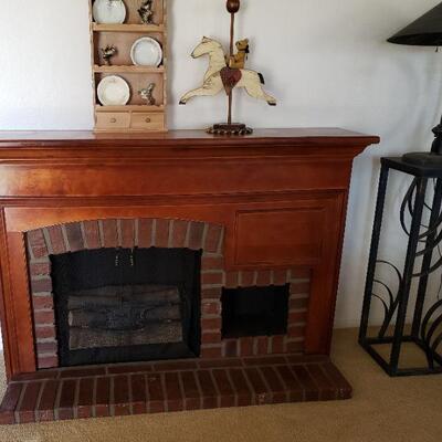 Faux electric fireplace with brick hearth.